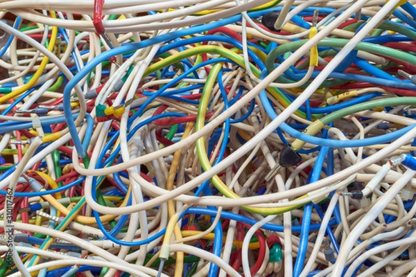 Fototapeta The bunch of electric wires of different colors are very much intertwined. On tangled wires is wire-end ferrules and markings. Chaos, confusion, tangle. Abstract background.
