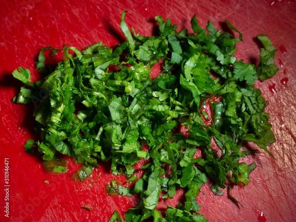 Obraz fresh chopped greens lying on a cutting board