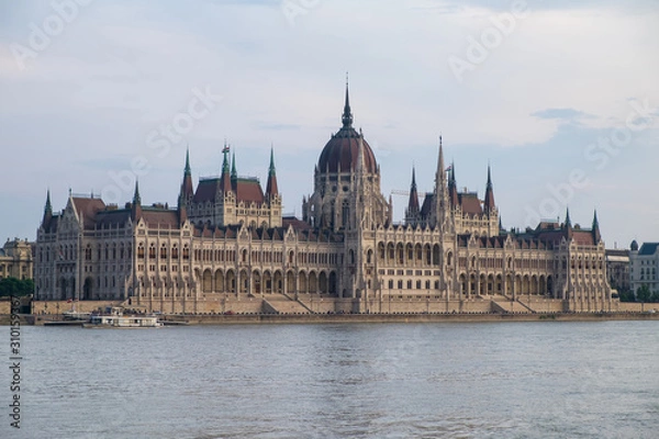 Fototapeta View of historical building of Hungarian Parliament on Danube river in Budapest, Hungary, Europe.