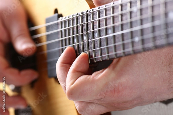 Fototapeta Male arms playing classic shape electric guitar