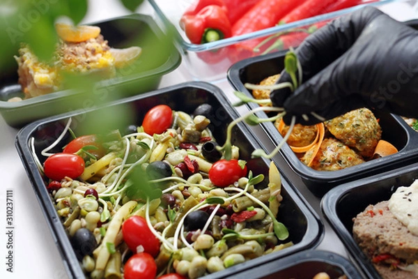 Obraz Meal prep containers, the chef prepares a meal in a boxed diet delivered to order.