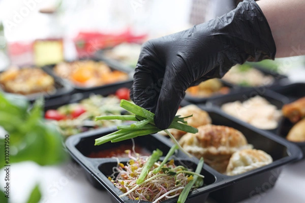 Fototapeta Meal prep containers, the chef prepares a meal in a boxed diet delivered to order.