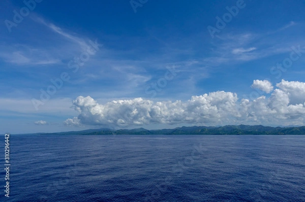 Fototapeta The hazy and mountainous coastline of the Caribbean Island of Haiti as a cruise ship sails by.