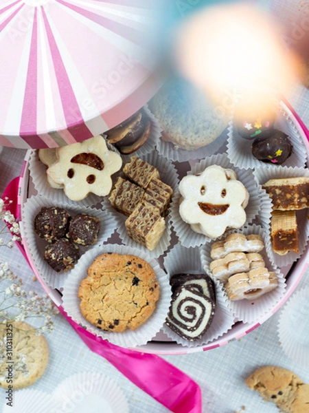 Fototapeta Festive pink box with variety of small cookies inside