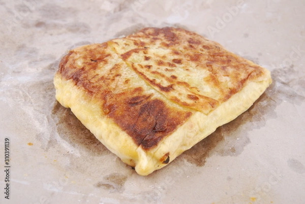 Fototapeta Close up of murtabak on paper parchment