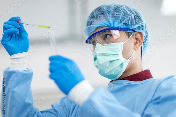 Obraz Asian scientists wear protective clothing while doing medical research in a science lab.