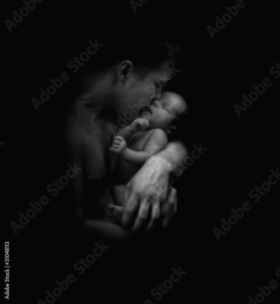 Obraz Father hugging a newborn baby, b/w