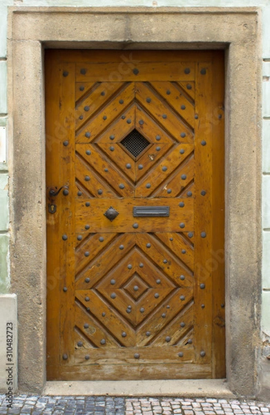 Fototapeta Wooden door with forged elements in high resolution