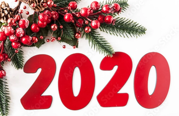 Fototapeta Christmas balls, berries and cones with copy-space on white paper background.  Holidays background