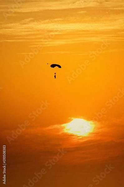 Obraz Man parachuting at sunset