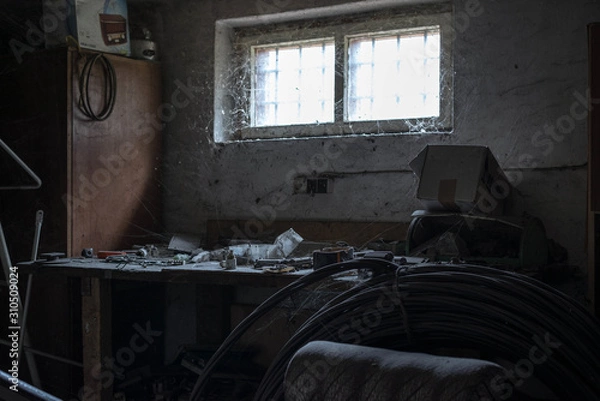 Fototapeta Old rusty workshop placed in bacement