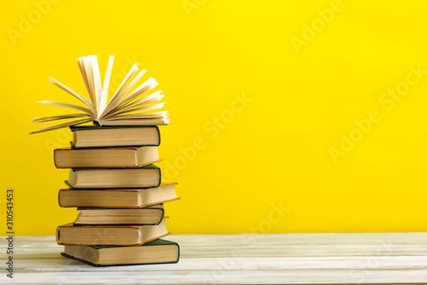 Fototapeta Open book, hardback books on wooden table. Back to school. Copy space.