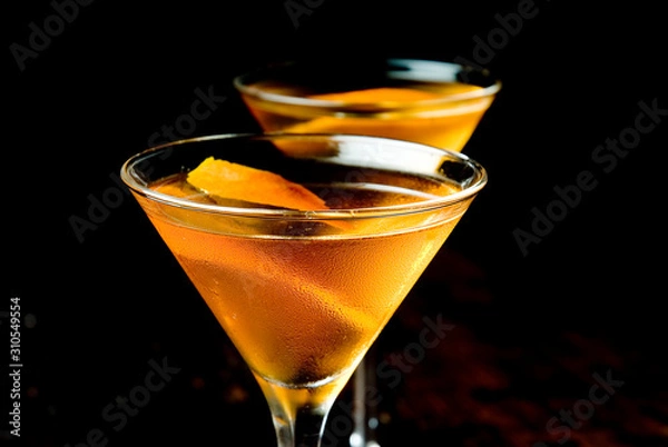 Obraz Mixed cocktail in two martini glasses with black background