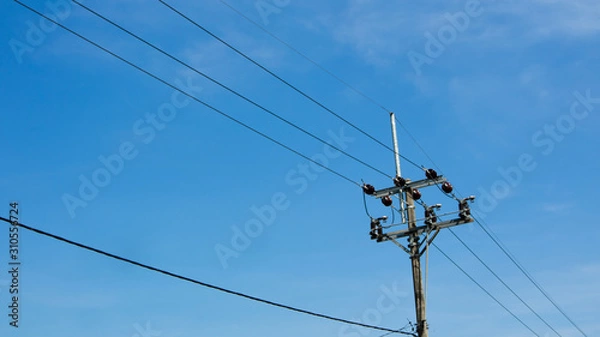 Fototapeta Electric poles against a cloudy blue sky background. Spring has come