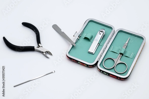 Fototapeta Set of manicure instruments and tools with the case isolated on white background. Scissors, Nail Cutter, Cuticle Pusher, Cuticle Nipper, Nail Buffer, Nail File, Nail Brush.