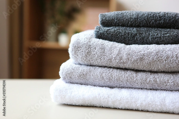 Fototapeta a stack of fresh towels on the table.