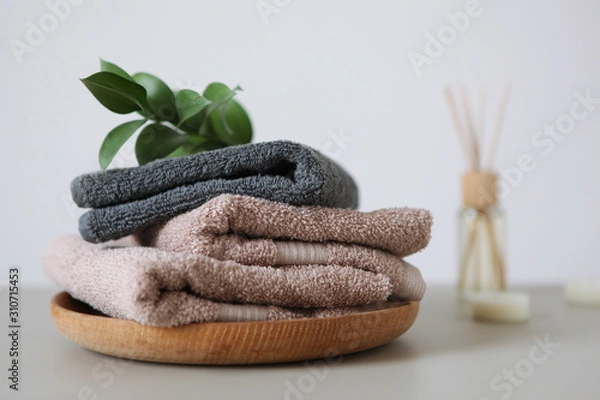 Fototapeta a stack of fresh towels on the table.