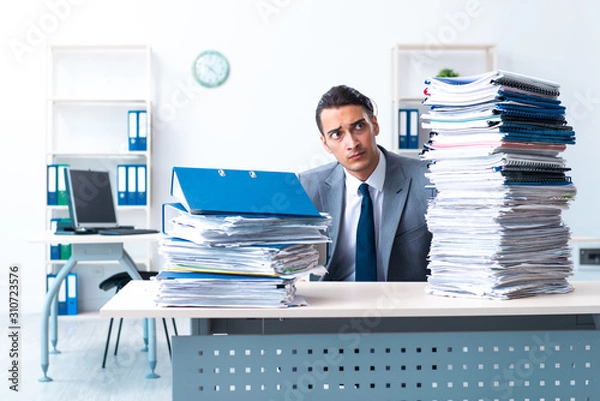 Fototapeta Businessman with heavy paperwork workload