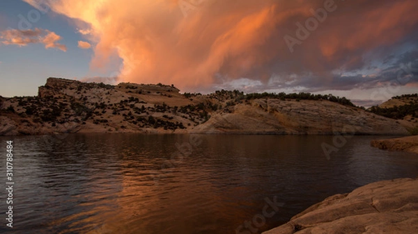 Fototapeta Colorful sunset reflecting in desert lake at Red Fleet Reservoir in Utah.
