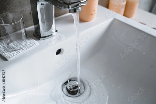 Obraz Modern bathroom faucet, Very high end faucet, sink, and counter in a luxury bathroom