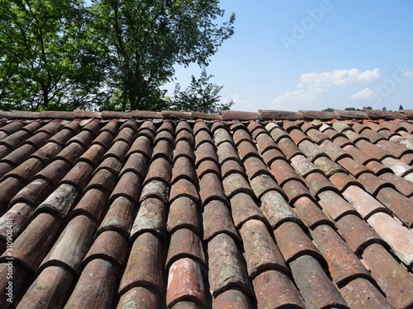 Fototapeta Roof in the foreground with brick tiles