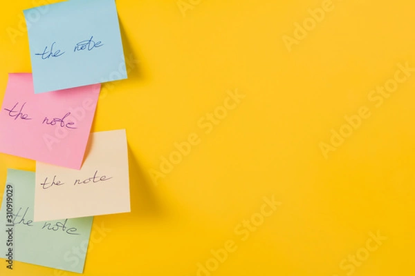 Fototapeta Paper stickers with the inscription on a yellow background