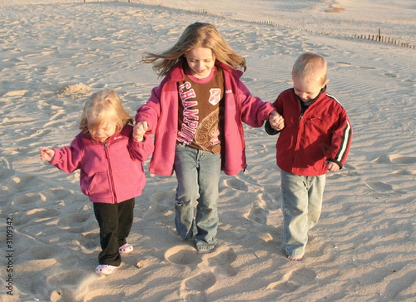 Obraz three kids walking together at beach
