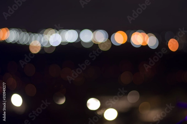 Fototapeta Nightlife concept background. Beautiful night city with colorful bokeh circles.