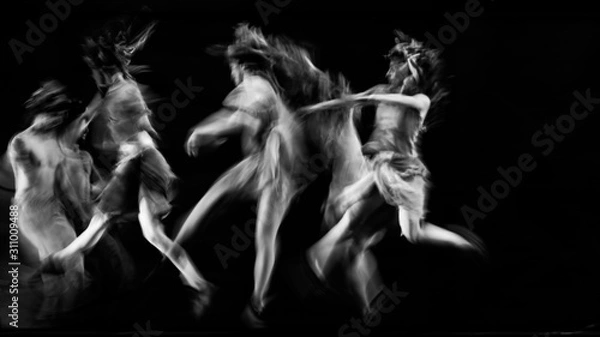 Fototapeta  scenography of dancers dancing in black and white, blurred effect photography