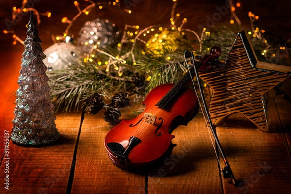 Obraz Exposition of violin and background with Christmas tree with light and candles, very beautiful composition, the best day in the year.
