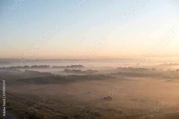 Fototapeta Fog over the fields, calm morning view. High-altitude photography.