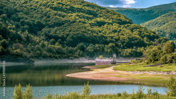Obraz Landscape side view of old church of St Nicholas. Usually partially submerged in Lake. Spring in National Park Mavrovo, North Macedonia.