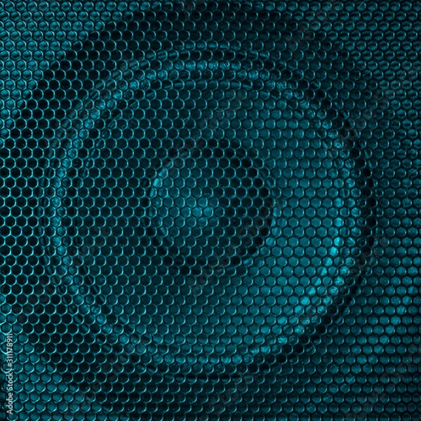 Obraz A close up macro photo of a speaker lit with a vibrant turquoise aqua teal flash gel