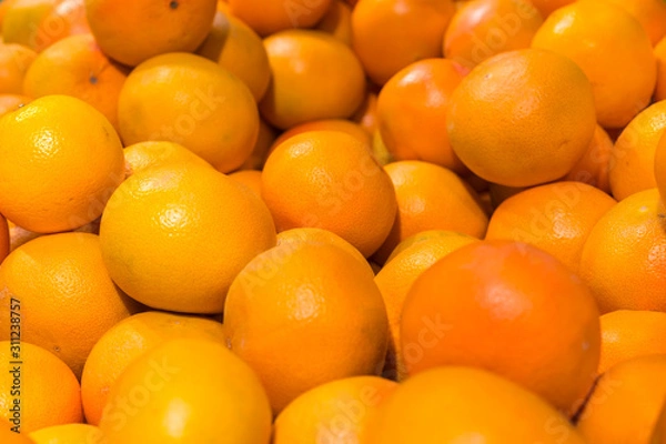 Fototapeta Fresh oranges in the store. Close up view of madarines orange on the sheft in the supermarket. Healty and fresh fruits background in a supermarket super store