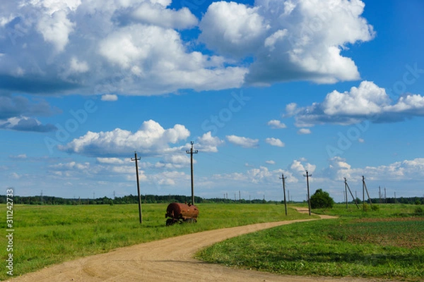 Obraz Rural road with rusty tank