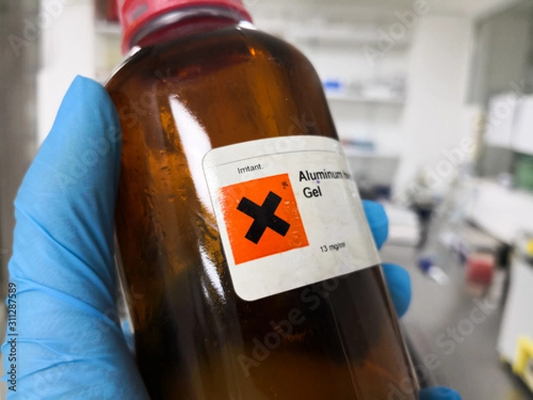 Fototapeta Dangerous and irritating chemical inside an amber bottle in a laboratory