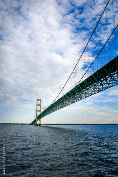Obraz The Mackinac bridge extends to the horizon above the waters of Lake Huron and Lake Michigan.