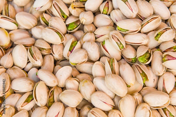 Obraz Roasted and salted pistachios in shell texture, background