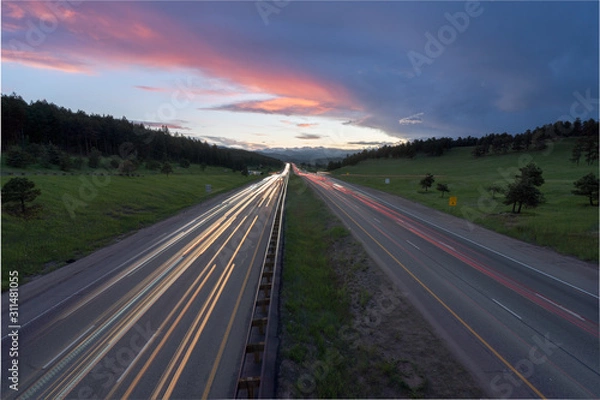 Fototapeta Car light trails with beautiful sunset over Buffalo Overlook at Genesee Colorado. Interstate-70 near Denver