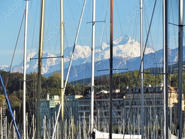 Fototapeta Geneva, Switzerland - October 18th 2019: a Beautiful autumn day in Lake Leman in Geneva. The Lake is surrounded by beautiful mountain that makes the sailing even more spectacular for the many sailors