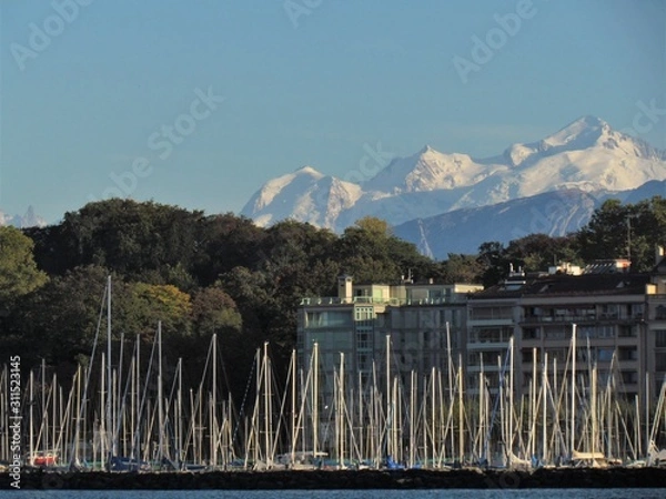 Fototapeta Geneva, Switzerland - October 18th 2019: a Beautiful autumn day in Lake Leman in Geneva. The Lake is surrounded by beautiful mountain that makes the sailing even more spectacular for the many sailors
