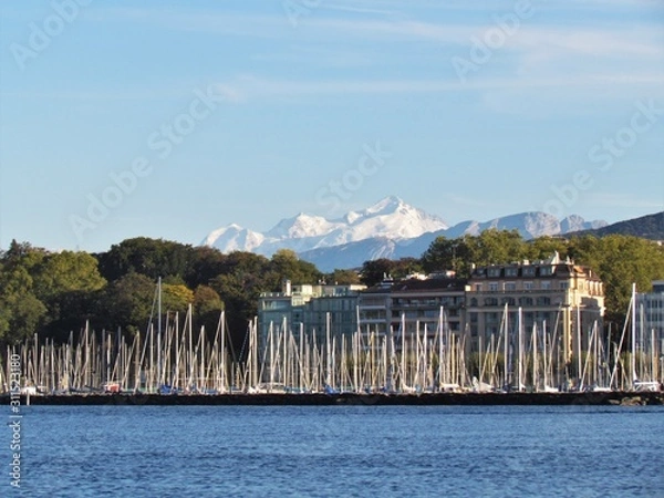 Fototapeta Geneva, Switzerland - October 18th 2019: a Beautiful autumn day in Lake Leman in Geneva. The Lake is surrounded by beautiful mountain that makes the sailing even more spectacular for the many sailors