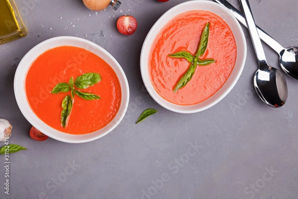 Fototapeta Tomato soup in bowls on gray stone table