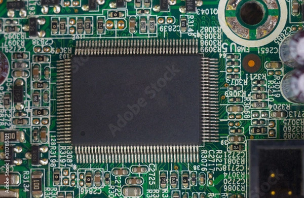 Fototapeta  computer microchip on a circuit board with electrical parts