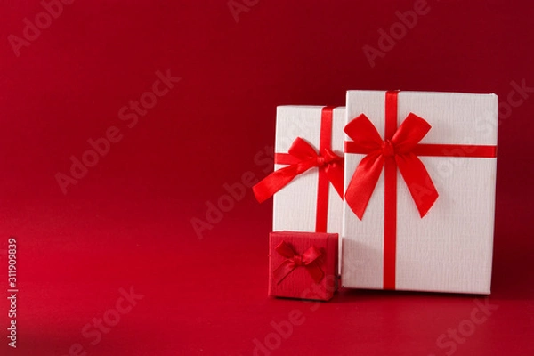 Obraz Assorted white gift boxes on red background. Copy space	