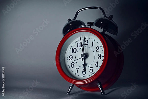 Obraz red alarm clock on dark background
