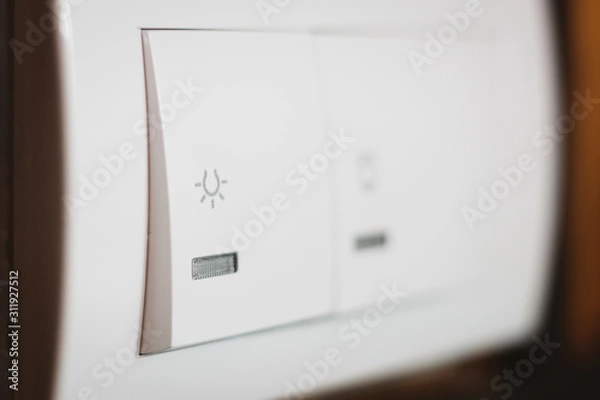 Fototapeta White light switch with icon on it, close up shot.