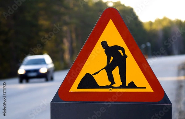 Obraz znak robót drogowych i samochód