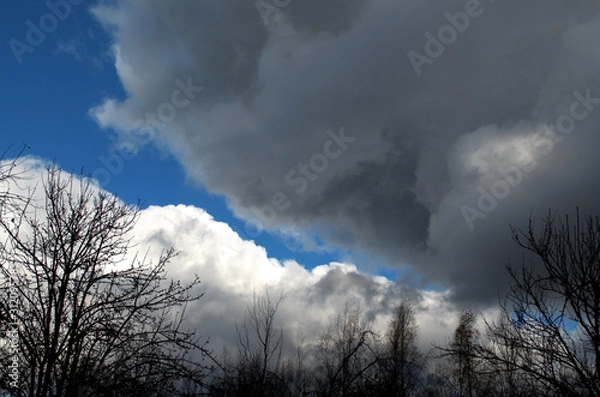 Fototapeta Blue sky before a strong storm with black clouds