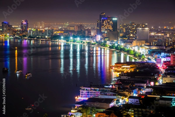 Fototapeta High view on viewpoint see cityscape with colorful light at the beach and the sea of ​​Pattaya Bay, beautiful landscape of Pattaya City at night scene landmark in Chonburi, Travel Asia to Thailand